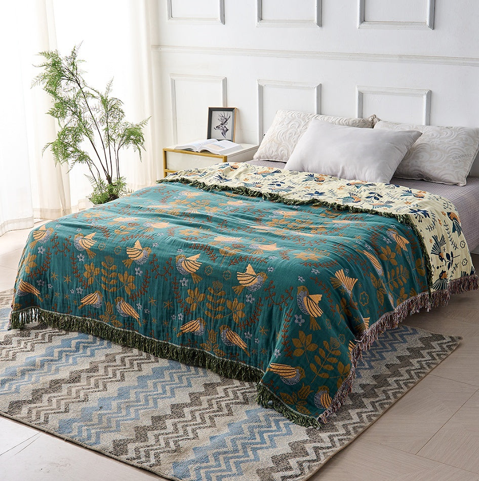 Plaid décoratif réversible bleu sarcelle et crème à franges