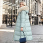 Manteau long matelassé à capuche en fausse fourrure et ceinture